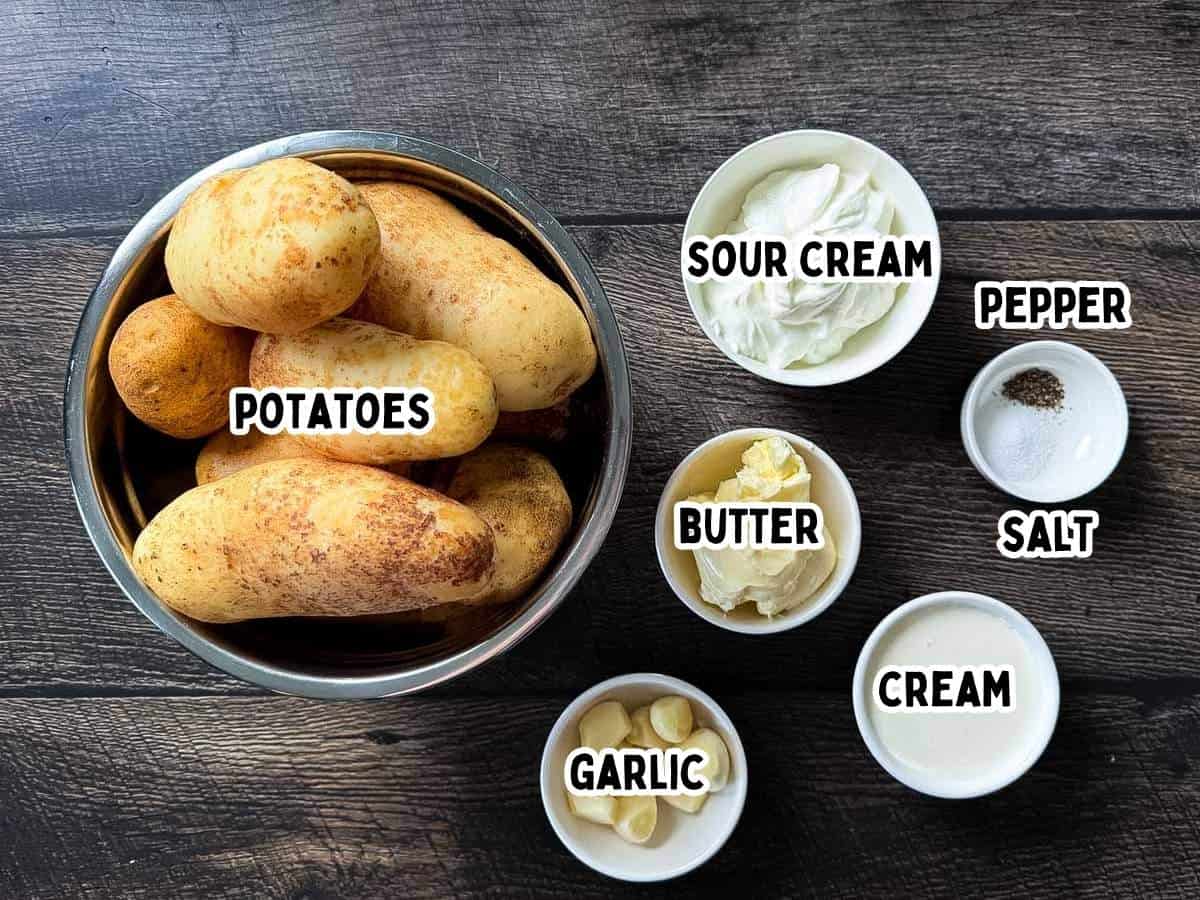 Labeled ingredients for smoked mashed potatoes including russet potatoes, sour cream, butter, garlic, salt, pepper, and cream.