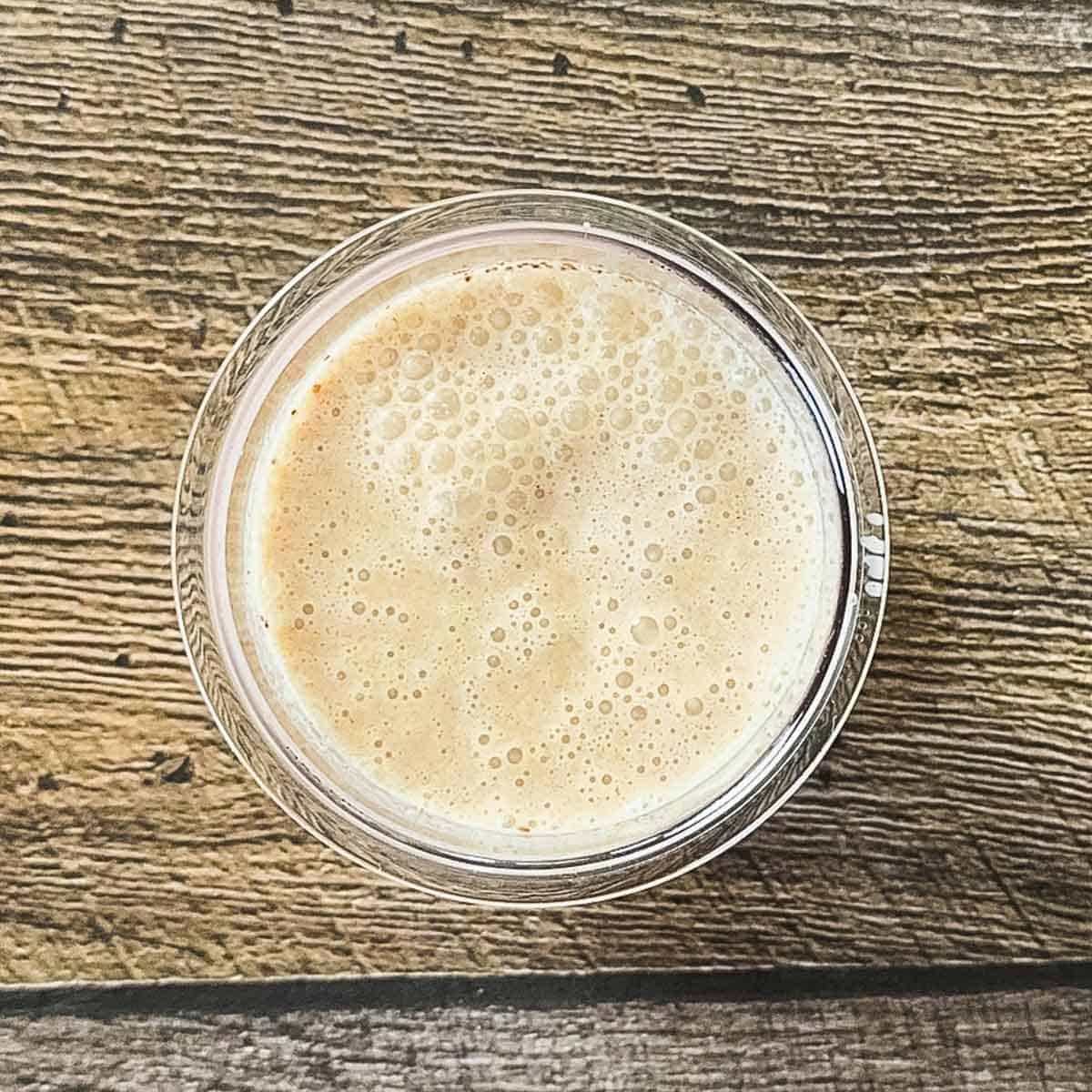 Apple pie ice cream ingredients blended in a pint container until smooth.