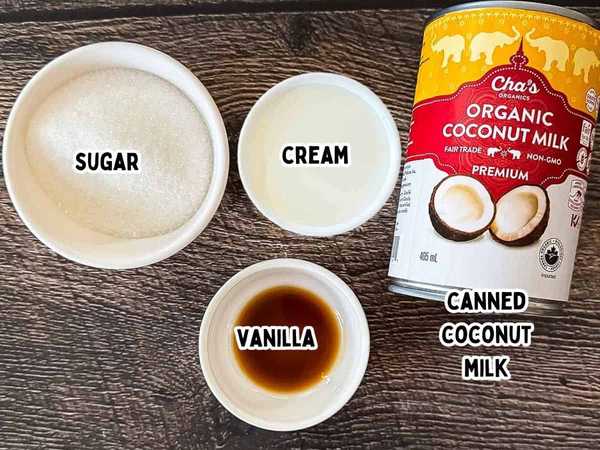 The labeled ingredients for Ninja Creami coconut ice cream in small white dishes on a wooden table.