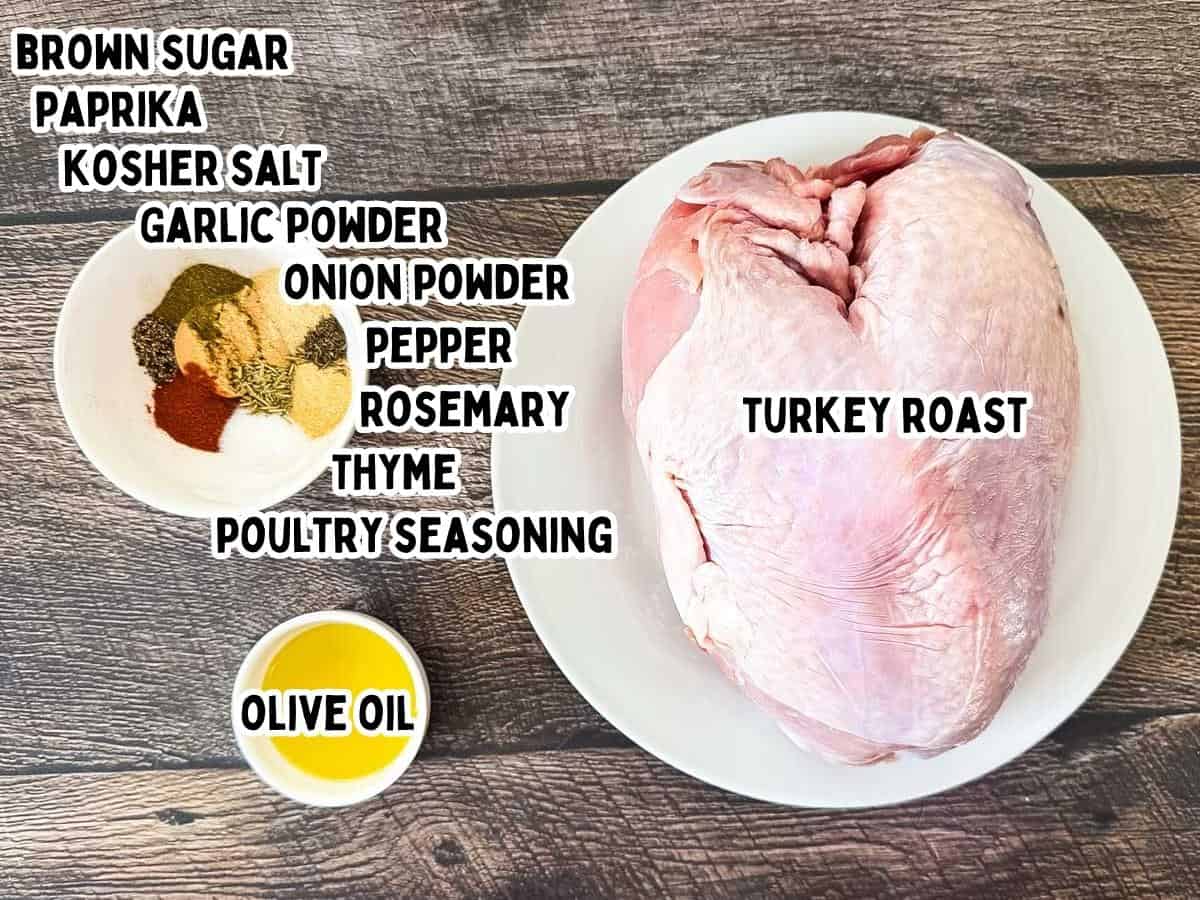 Raw bone-in turkey breast roast on a white plate with bowls of olive oil and spices, including brown sugar, paprika, kosher salt, garlic powder, onion powder, rosemary, thyme, and poultry seasoning.