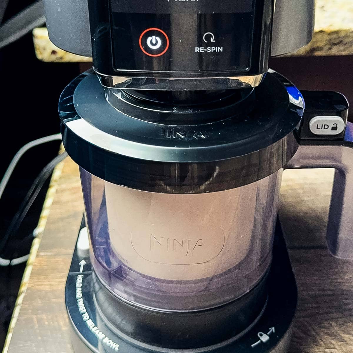 The coconut ice cream being processed in the Ninja Creami machine.