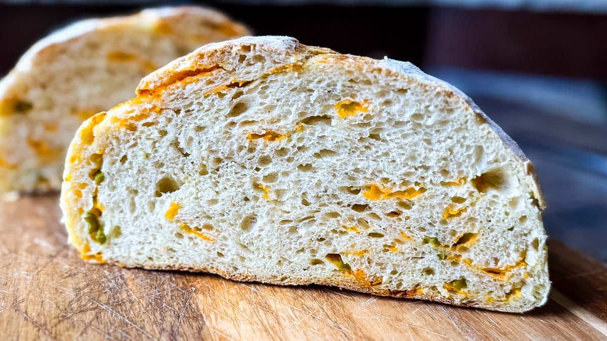 Close up of jalapeño cheddar sourdough bread crumb with melted cheese pockets.