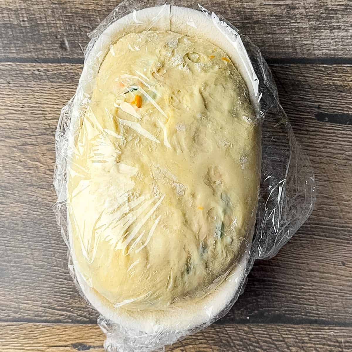 The jalapeno cheddar dough covered with plastic, after the second rise.