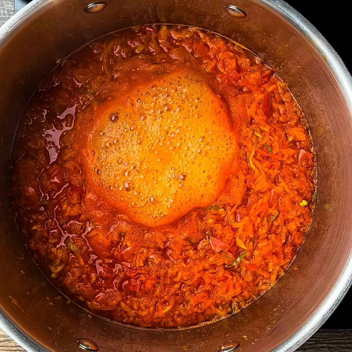 The ingredients for the jelly boiling in a pot.
