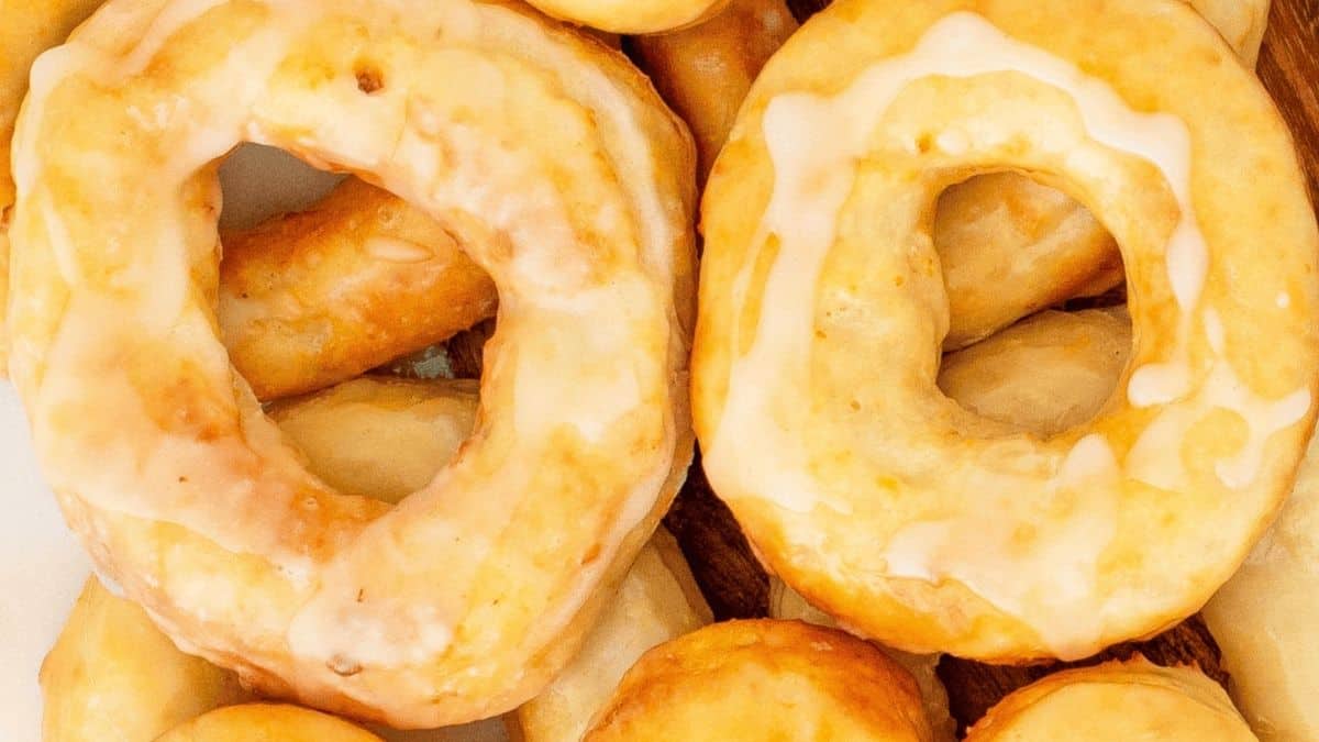 Air fryer sourdough discard donuts glazed and stacked on a plate.