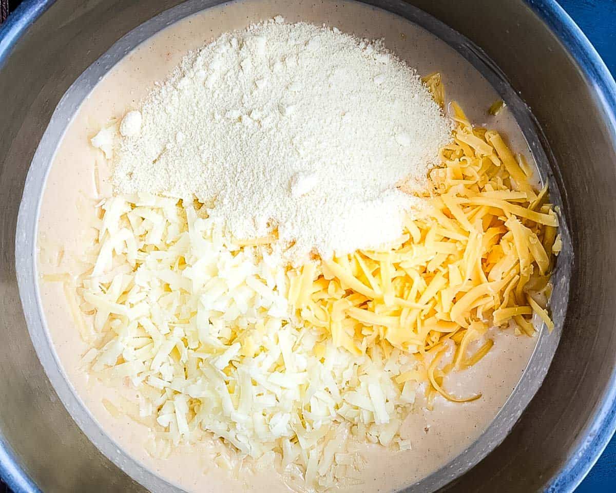 Shredded cheese added to the hot cream sauce before stirring.
