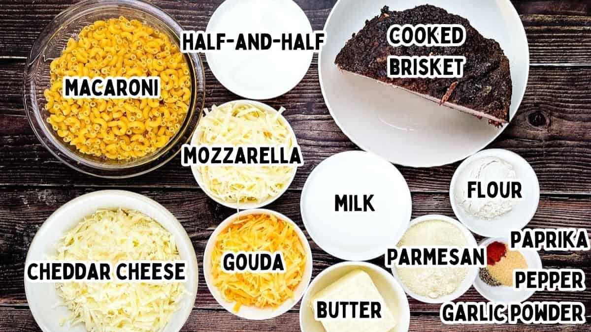 Ingredients for baked brisket mac and cheese arranged on a wooden surface.