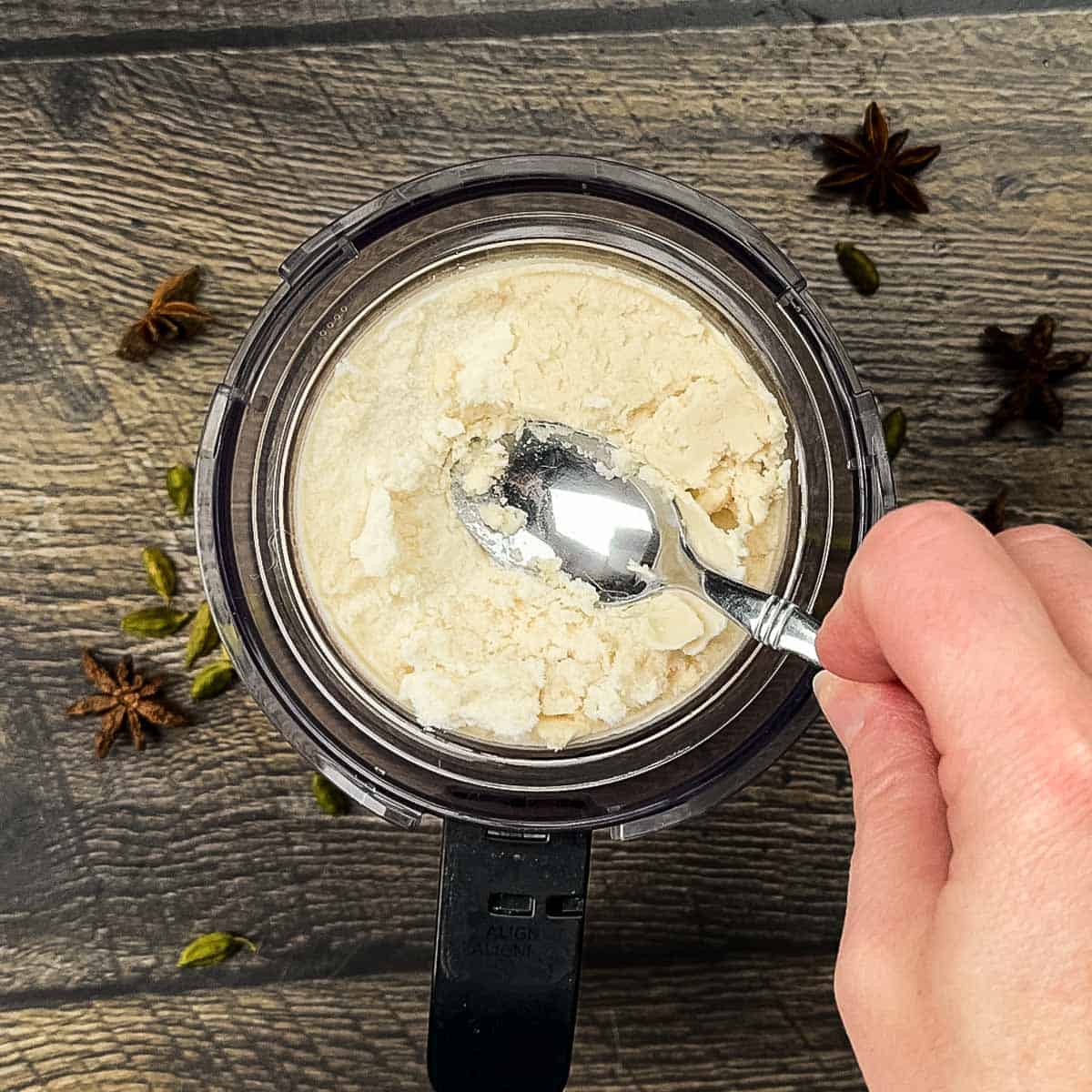 A small spoon making a well in the center of the crumbly ice cream.