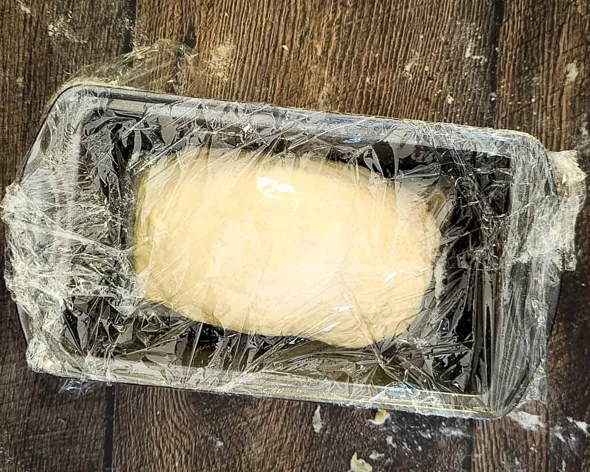 Shaped dough placed into a greased loaf pan.