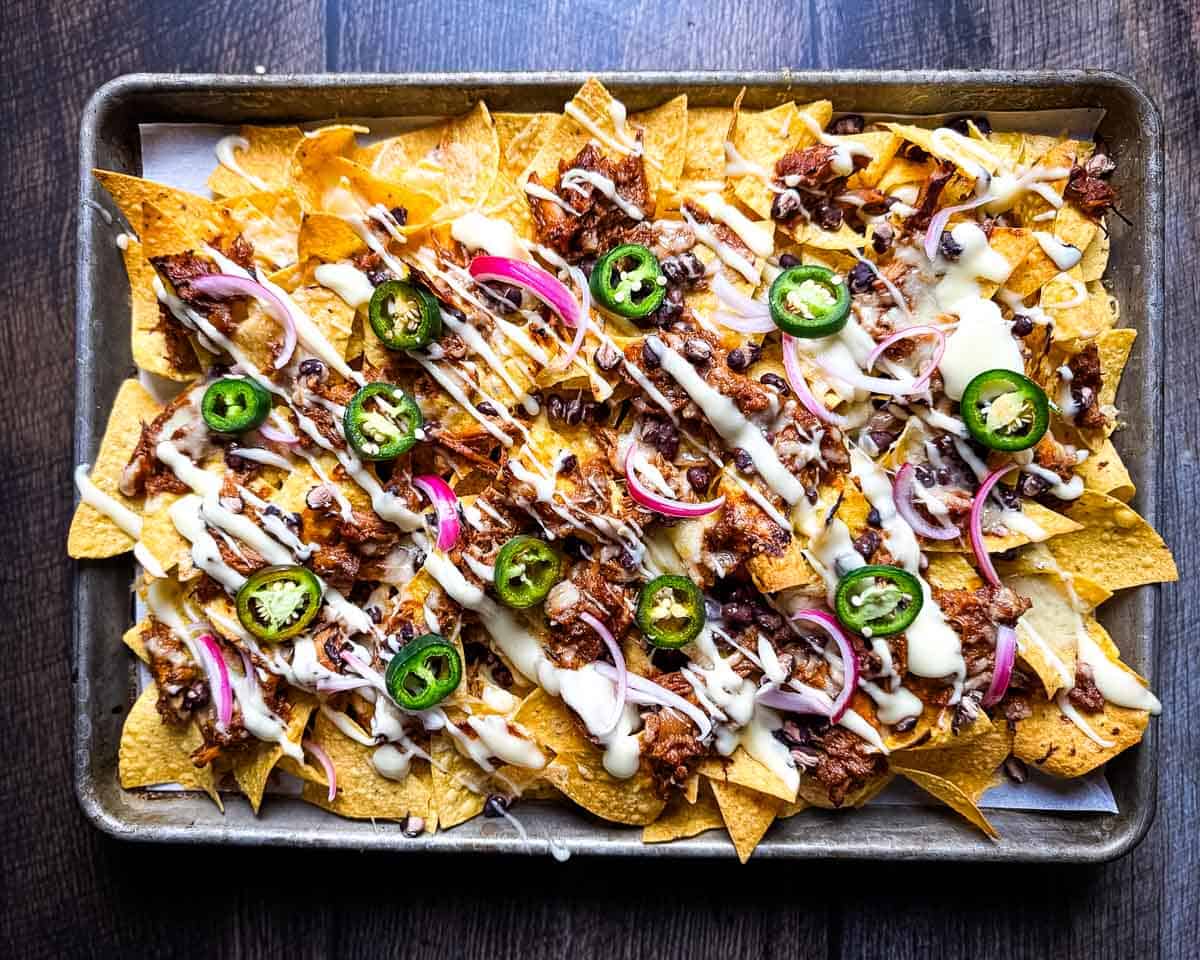 Baked pulled pork nachos with melted cheese fresh from the oven.
