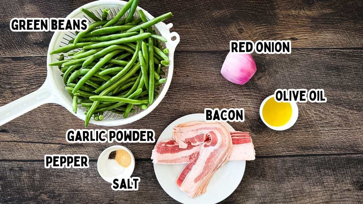 Labeled ingredients for smoked green beans with bacon on a wooden table.