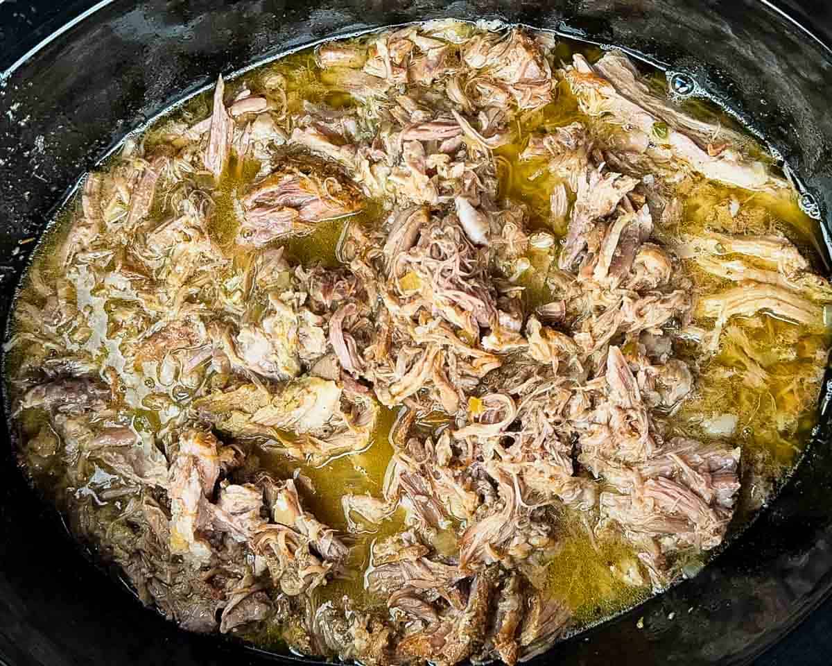 The shredded pork in the slow cooker with all the juices.