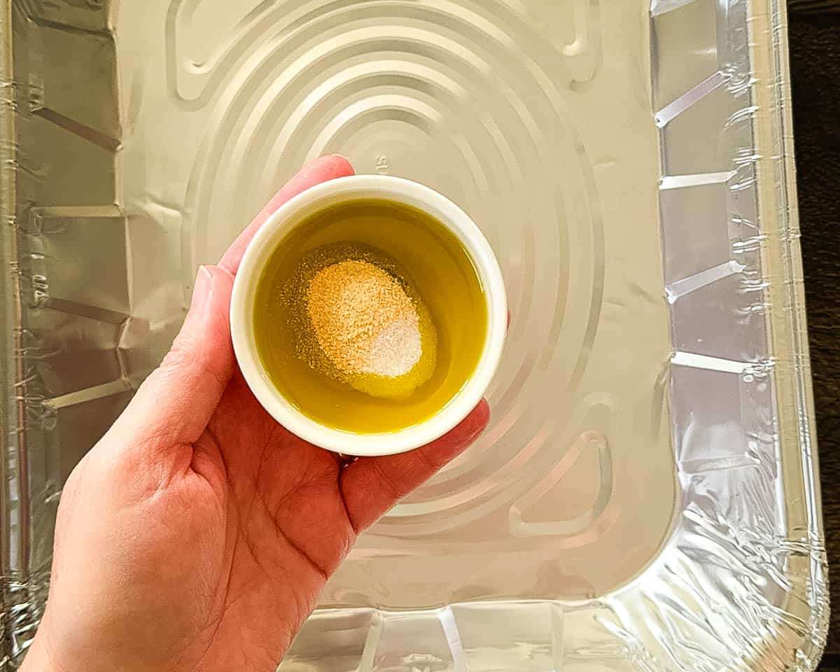 The oil and seasoning being combined in a small bowl.