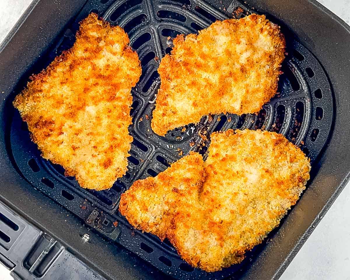 Air fryer pork tonkatsu cooked until golden brown and crispy in the air fryer basket.