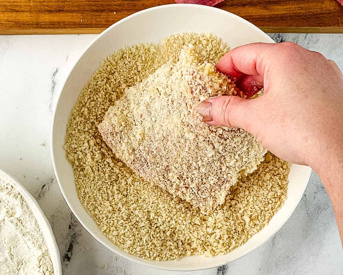 Pork cutlet fully coated in panko breadcrumbs ready for air frying.