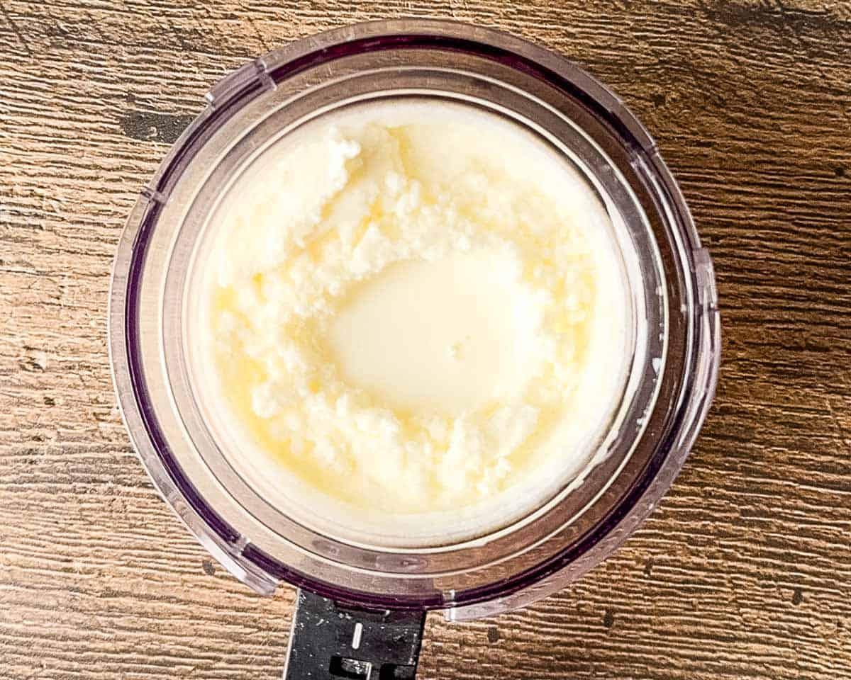 Adding a tablespoon of milk to the center of the frozen yogurt pint before the re-spin cycle.