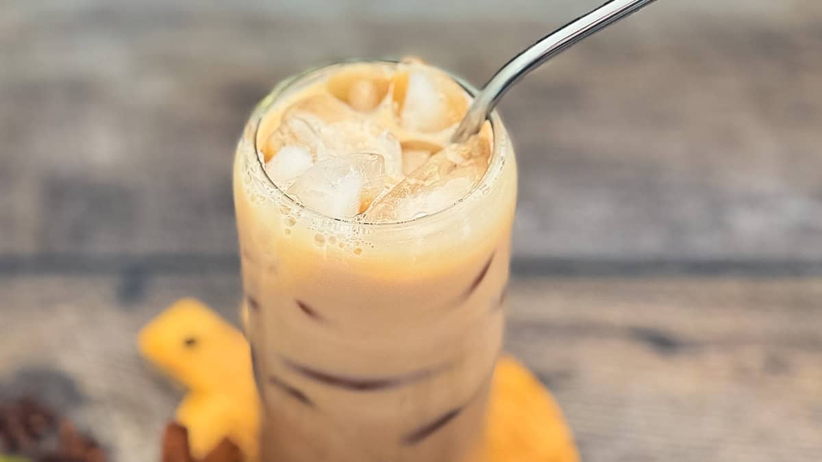 Iced Starbucks chai tea latte copycat in glass with ice and creamy milk.
