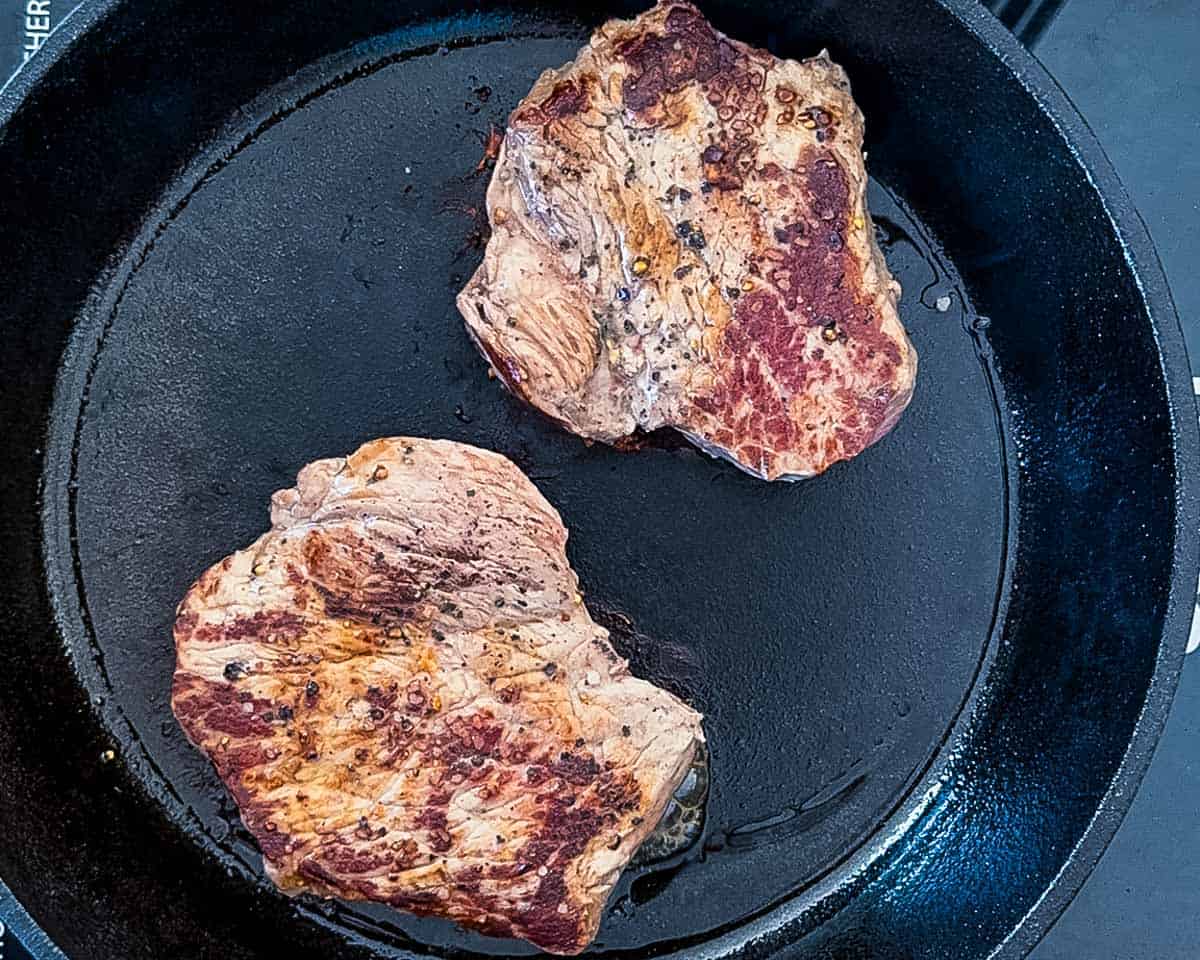 A deep golden brown crust on the seared steaks.