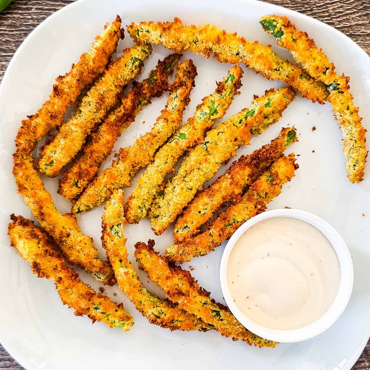 Air fryer green bean fries coated in crispy Parmesan panko breadcrumbs served with creamy dipping sauce.