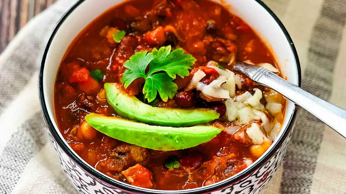 Hearty smoked brisket chili recipe made with leftover brisket, beans, tomatoes, and toppings.