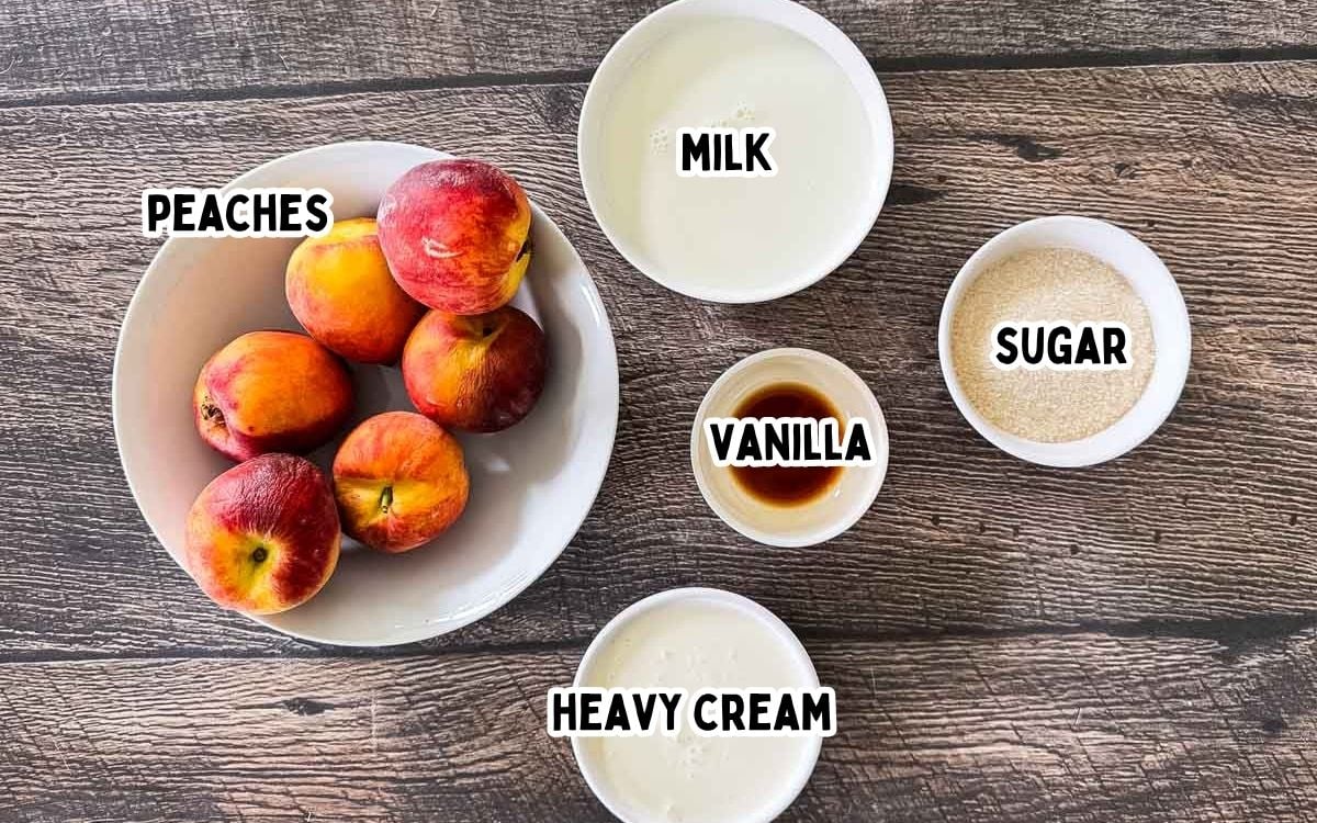 Labeled ingredients for peach ice cream laid out on a counter: fresh peaches, milk, heavy cream, sugar, and vanilla.