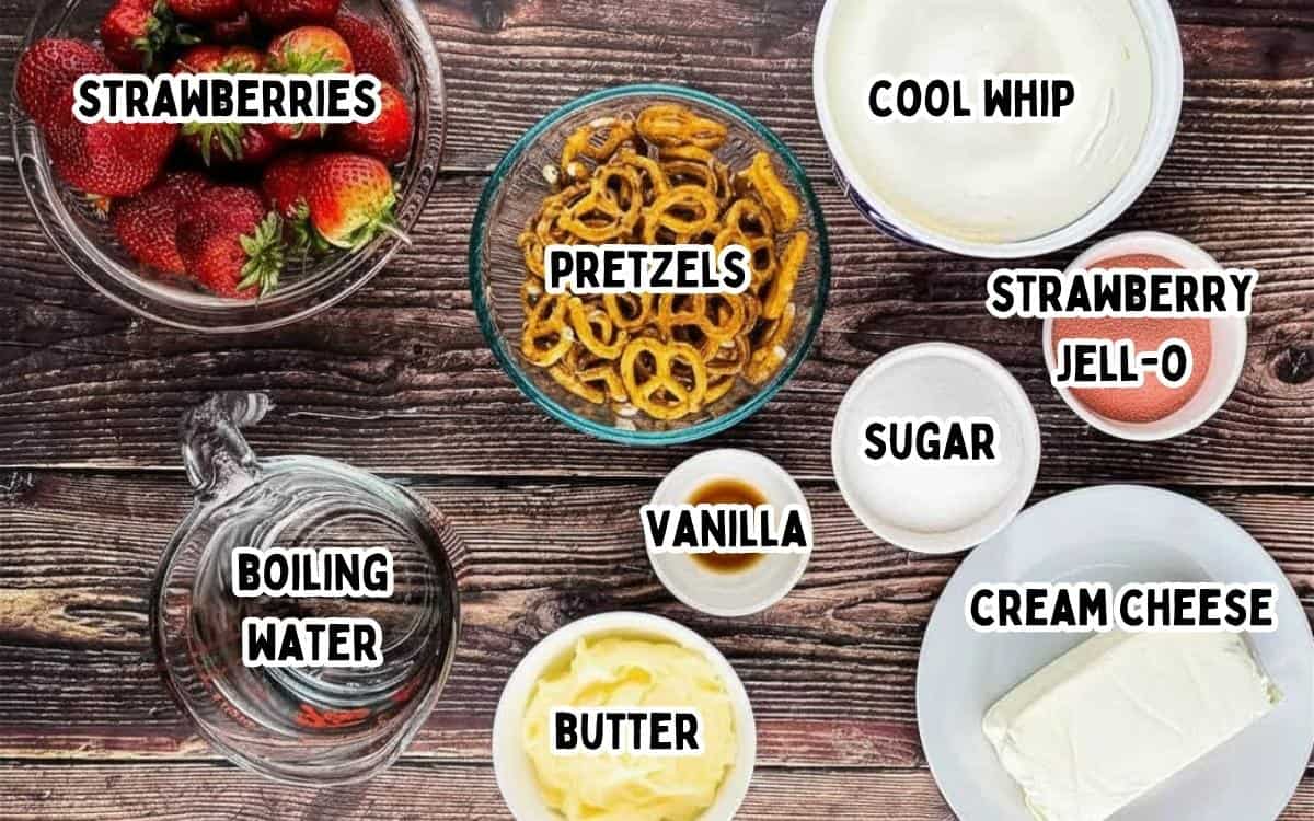 Ingredients for strawberry pretzel salad including pretzels, cream cheese, strawberries, strawberry Jell-O, butter, sugar, and Cool Whip.