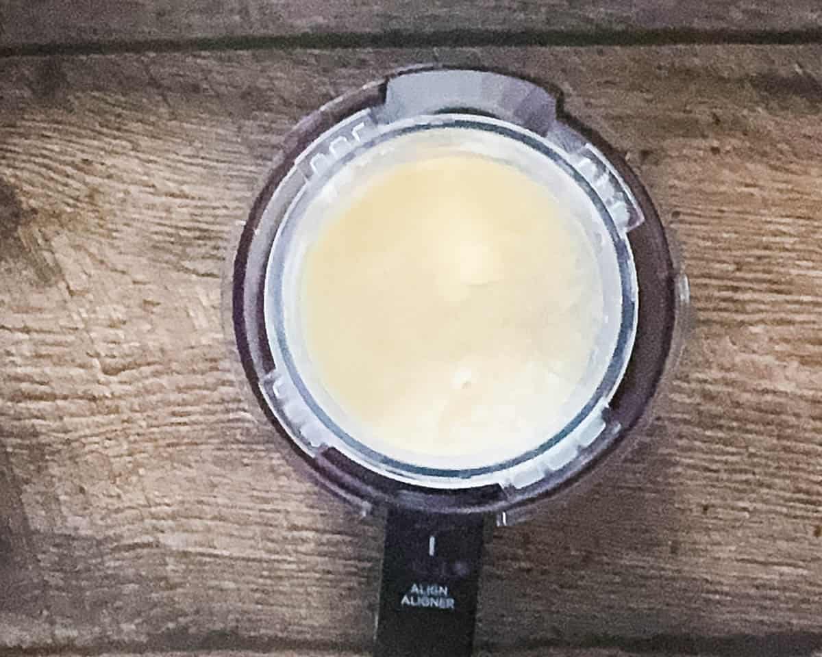 rozen lemon ice cream base in a Ninja Creami pint after 24 hours in the freezer.