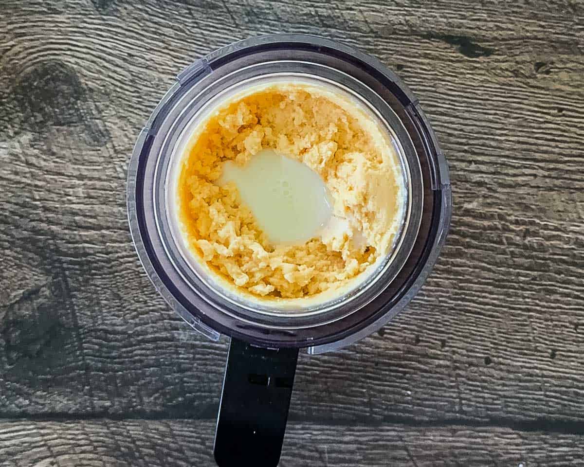 A tablespoon of milk added to the crumbly ice cream before respinning.