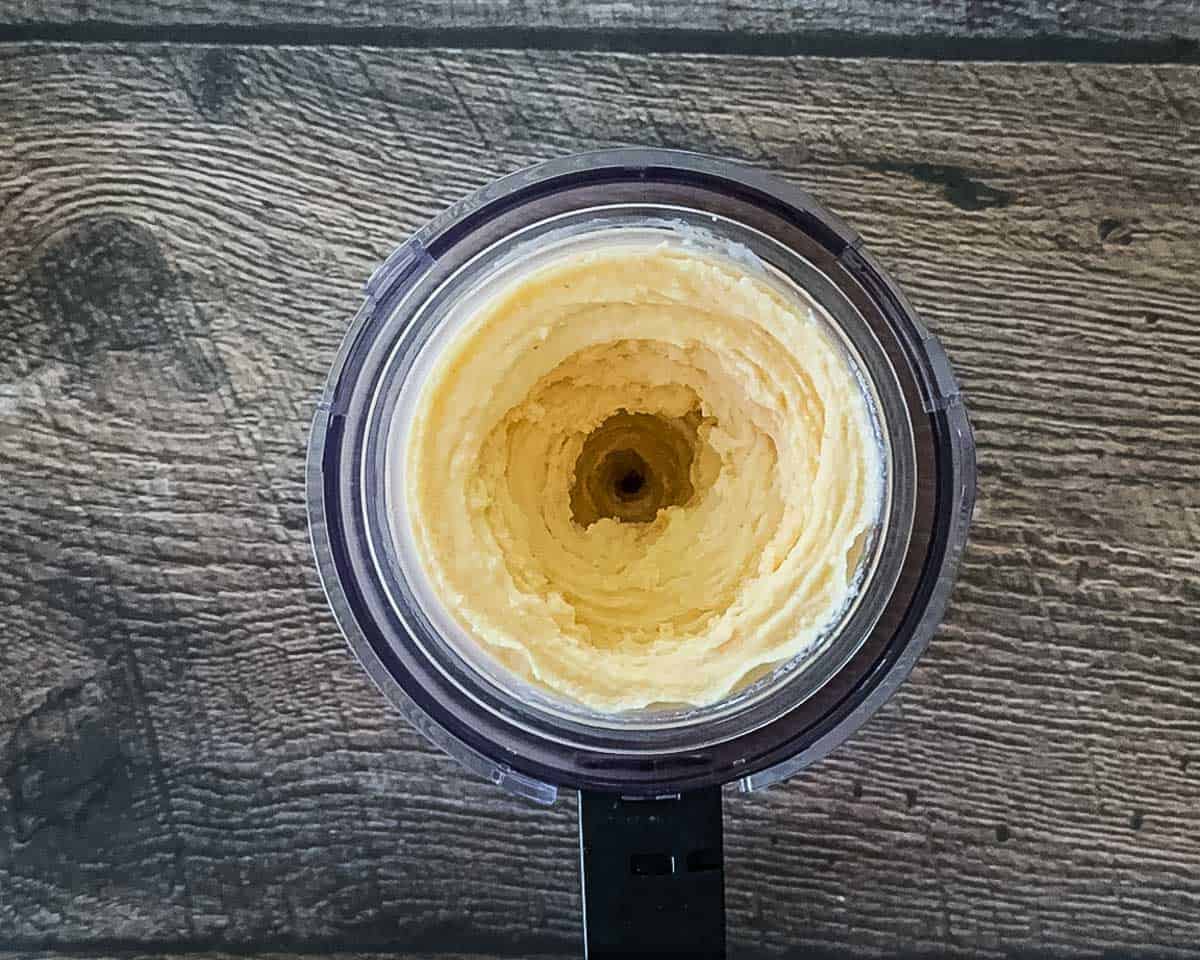 
Smooth, creamy peach ice cream in a Ninja Creami pint after respinning, ready to scoop.