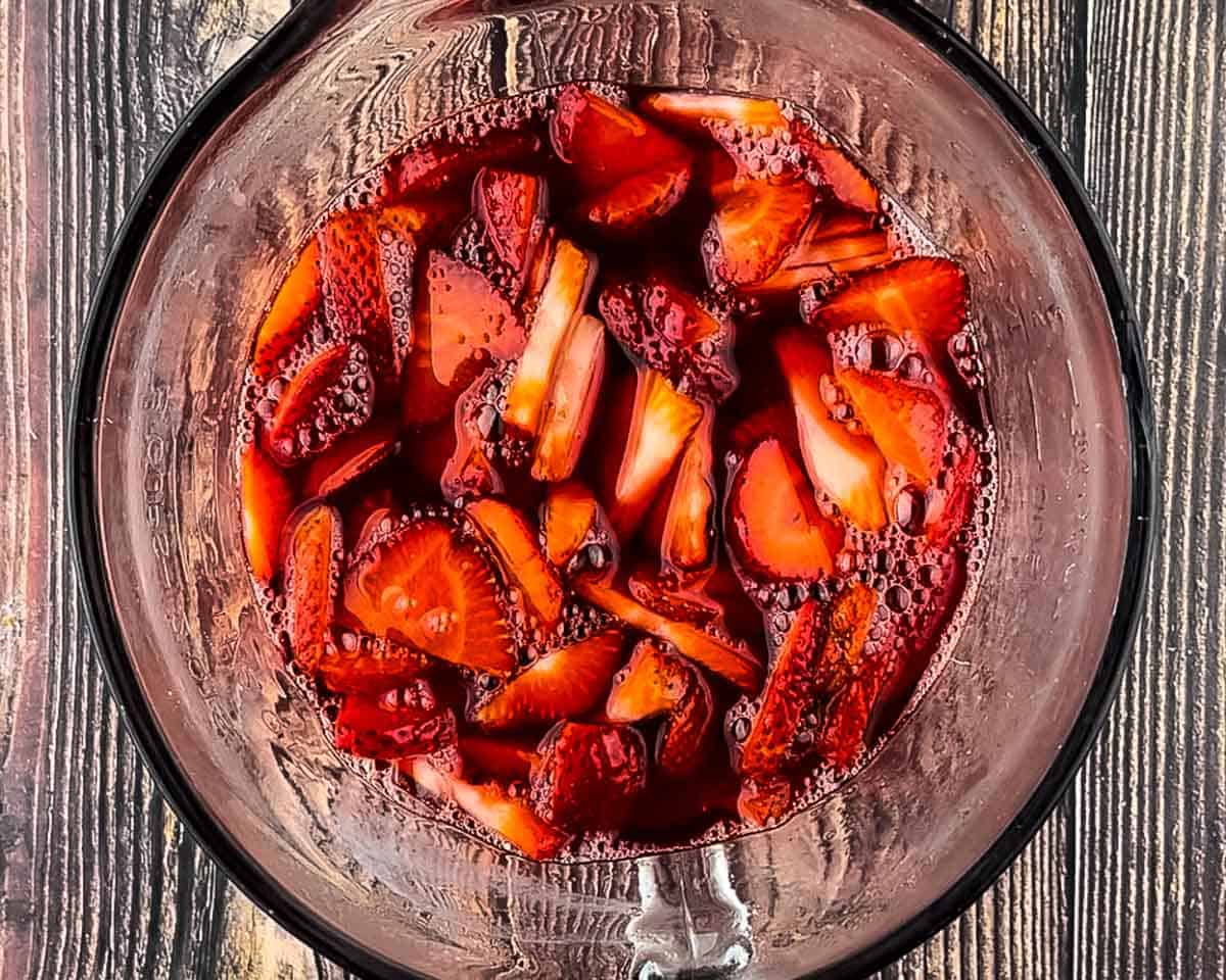 Fresh sliced strawberries mixed into strawberry Jell-O for the topping layer.