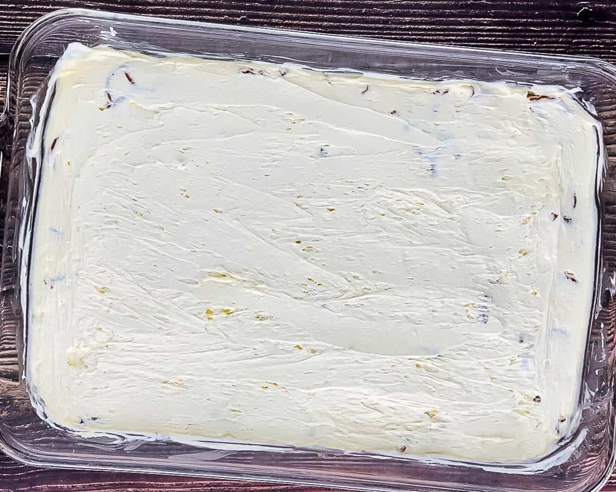 The cream cheese mixture spread evenly over the cooled pretzel crust.