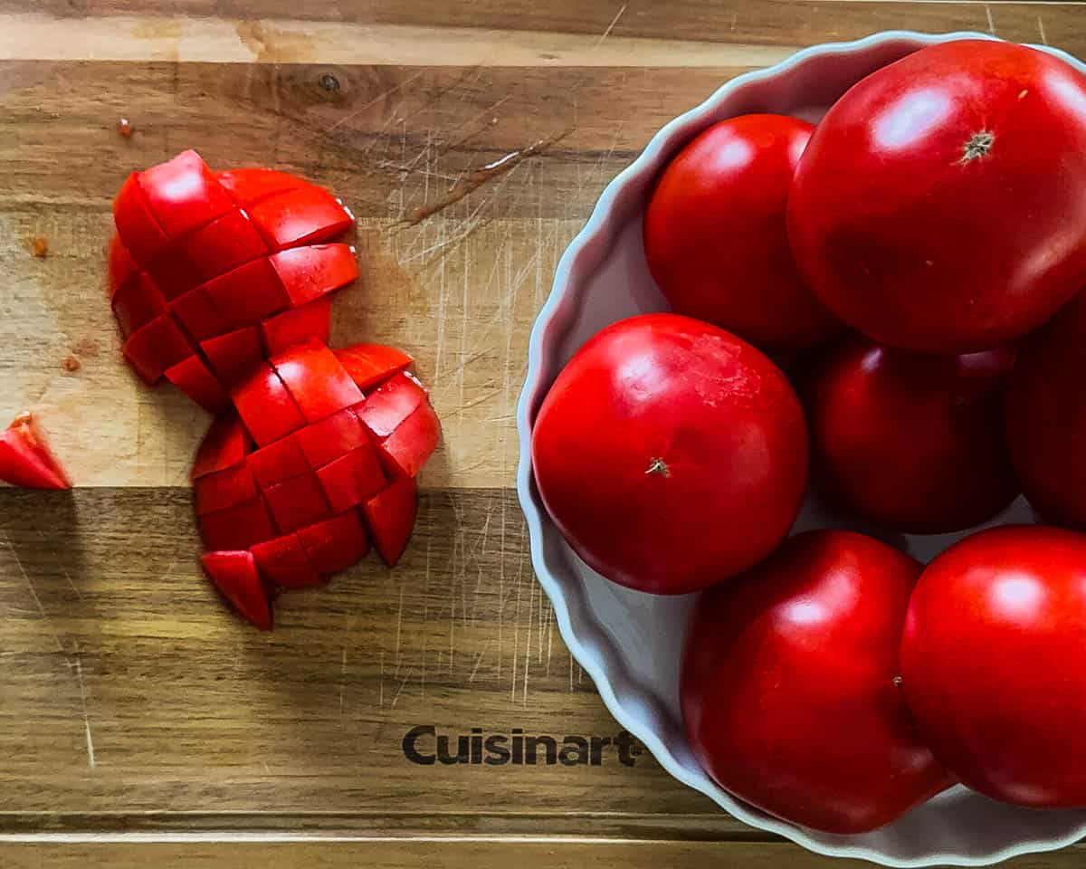 Chopped fresh tomatoes on a wooden cutting board.