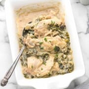 A casserole dish filled with creamy smothered chicken.