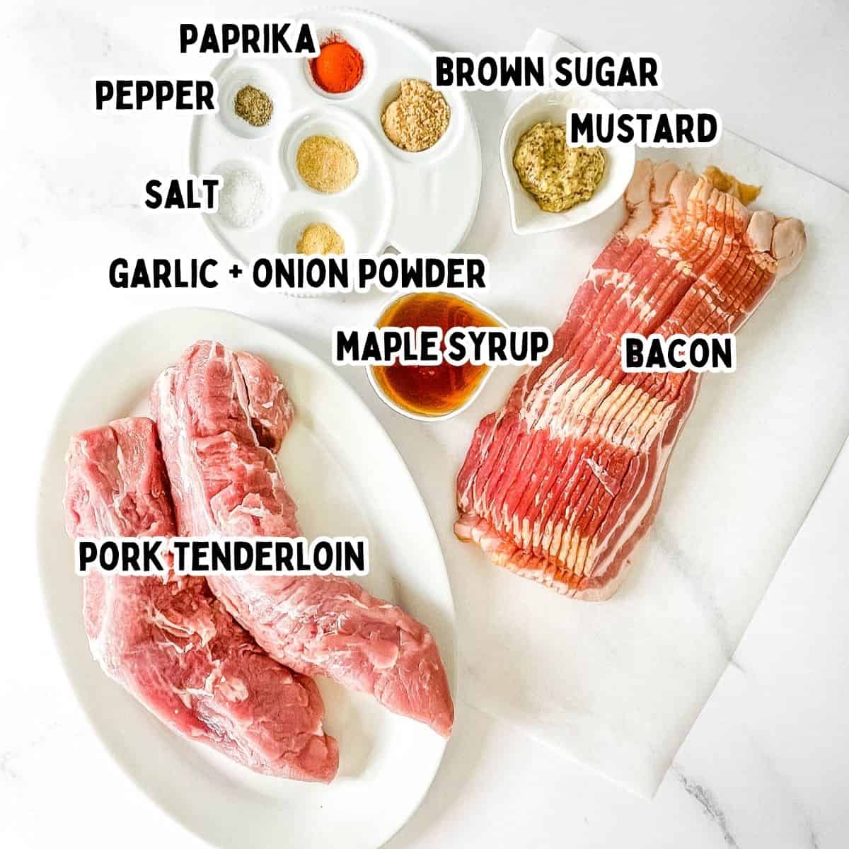 The labeled ingredients for smoked bacon-wrapped pork tenderloin placed on a white counter.