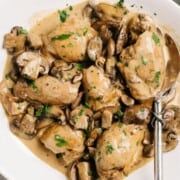 Instant pot chicken thighs on a serving platter with mushroom gravy.