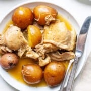 A plate full of instant pot chicken thighs and potatoes.