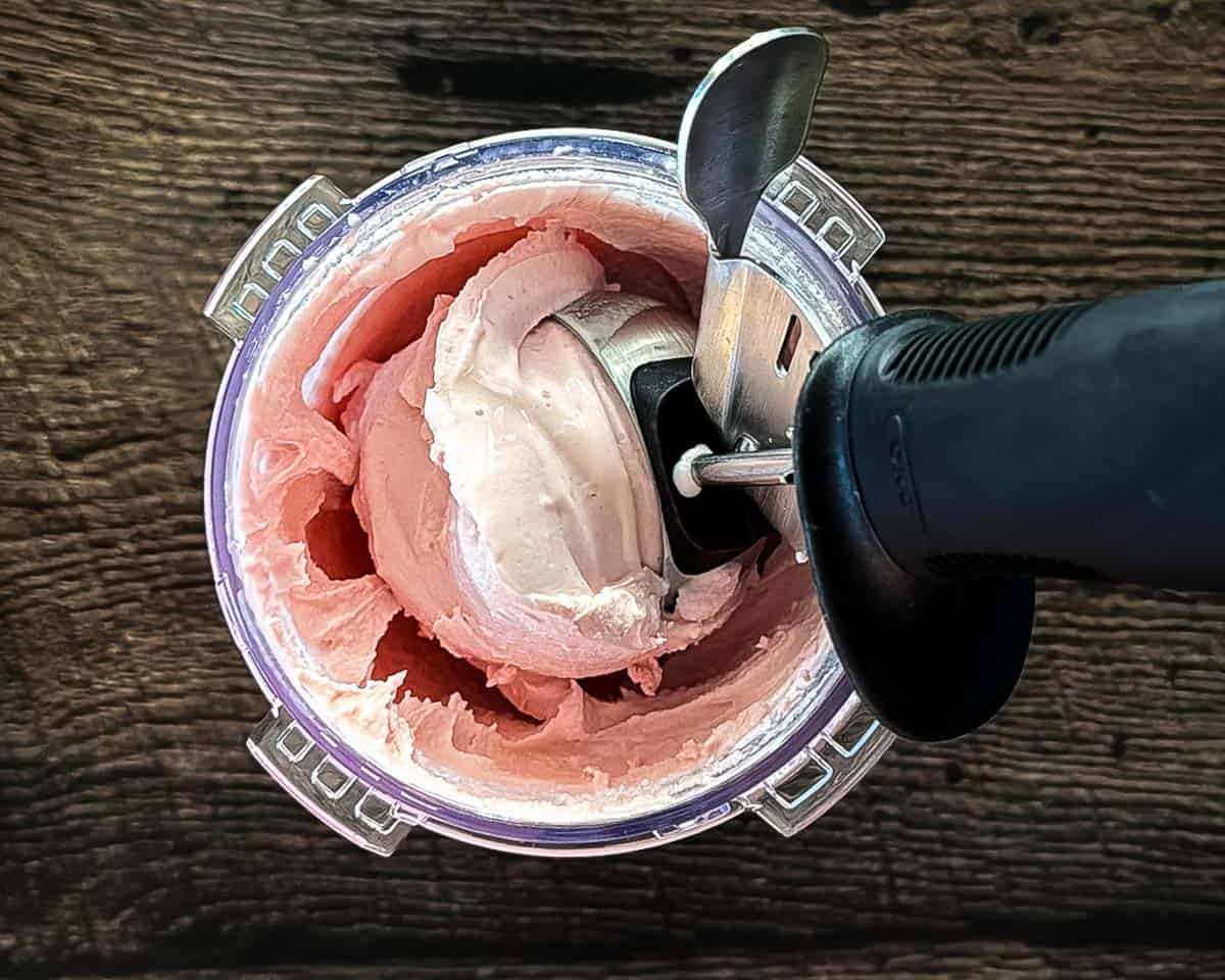 Scooping up the high protein ice cream with an ice cream scoop.
