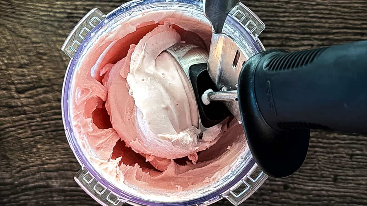 Ninja Creami strawberry cottage cheese ice cream being scooped up with an ice cream scoop.