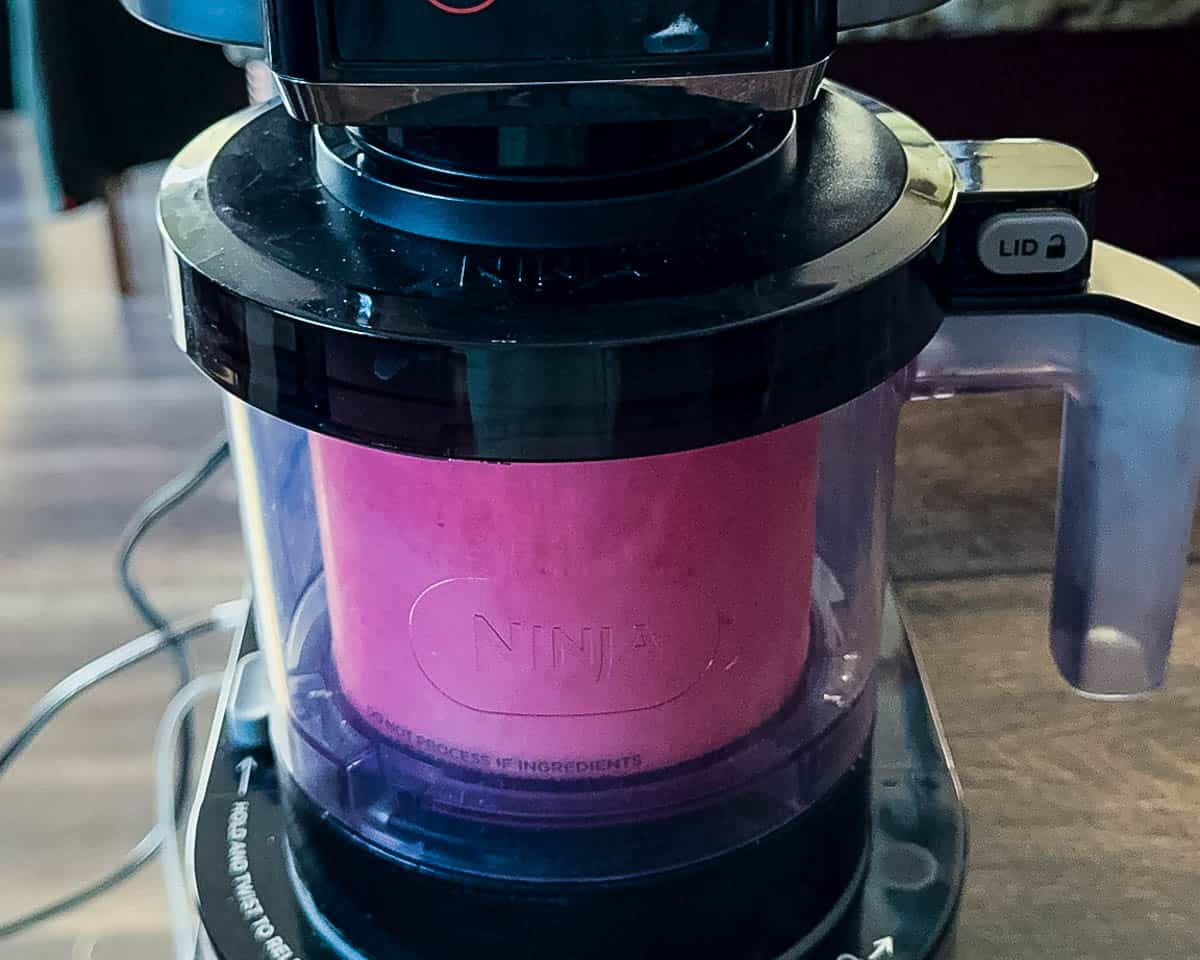 The ice cream being processed in the Ninja Creami machine.