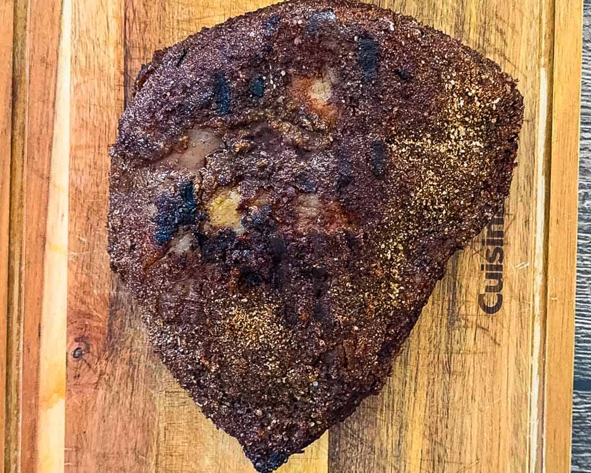 Smoked sirloin cap roast resting on a cutting board after cooking.