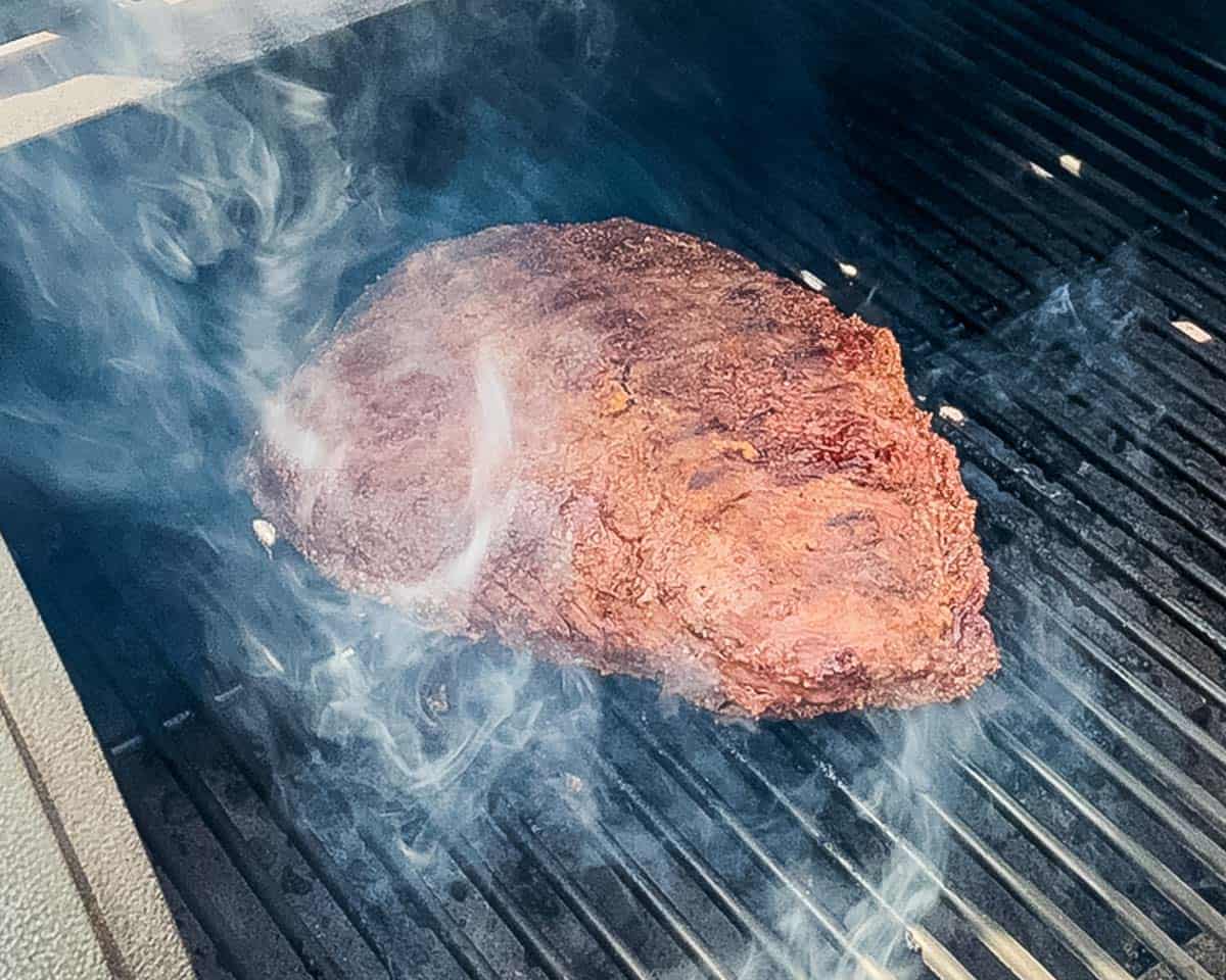 The roast searing on the pellet grill, now showing visible grill marks.