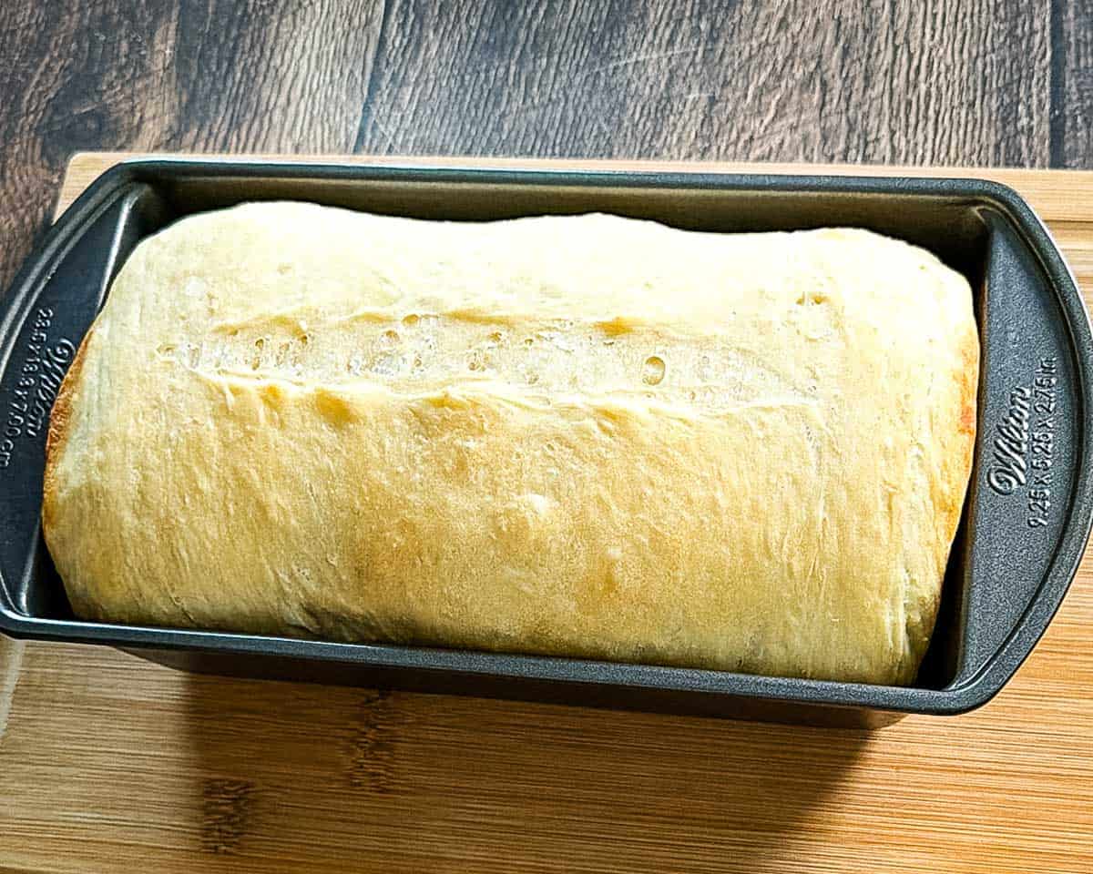 The loaf after the loaf pan used as a cover is removed, before it goes back in for the final bake to darken the top.