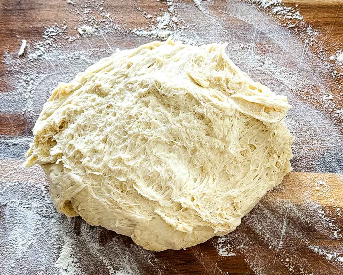 The dough after the first rise on a floured surface.