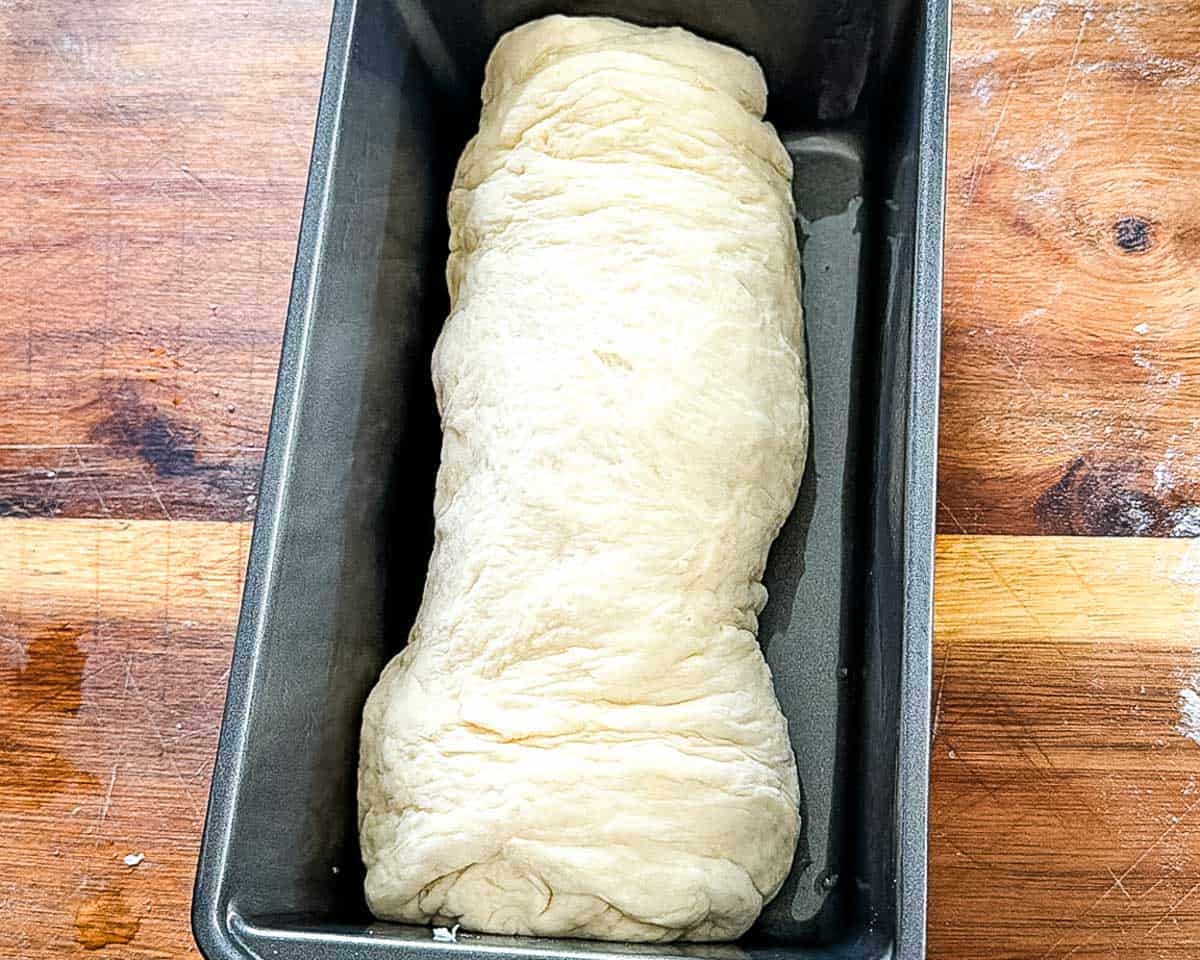 The dough in a loaf pan for the second rise.