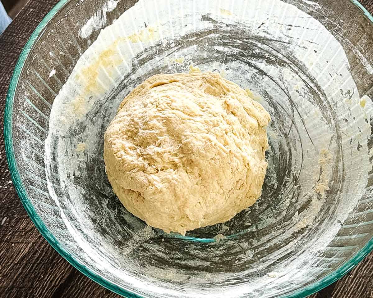 The dough combined and formed into a smooth ball in a mixing bowl, ready for the first rise.