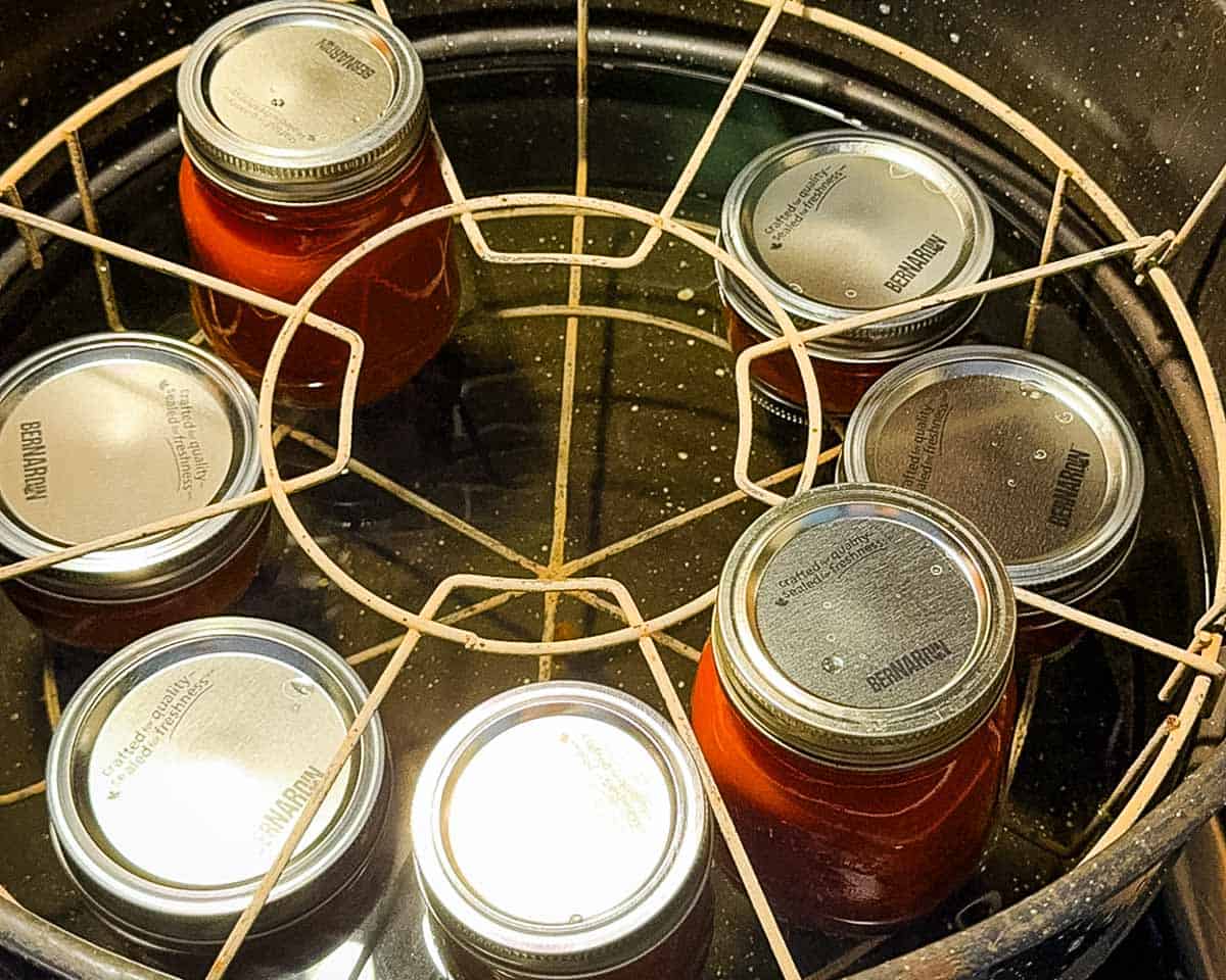 Jars of homemade pizza sauce in a boiling water bath canner after they were processed.