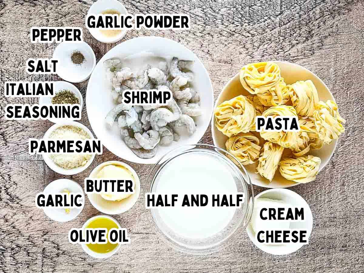 Labeled ingredients for Olive Garden shrimp Alfredo copycat recipe including shrimp, fettuccine, half and half, cream cheese, Parmesan, butter, garlic, and seasonings.