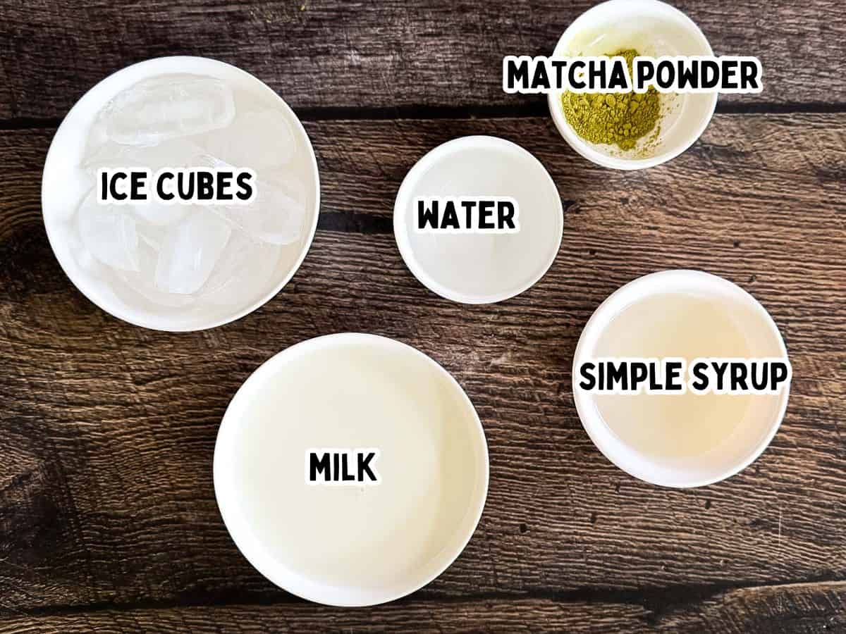 Labeled ingredients for a Starbucks iced matcha latte with matcha powder, milk, water, simple syrup, and ice.