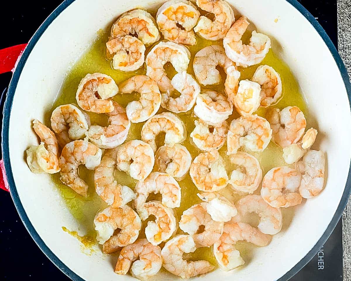 Seasoned shrimp sautéed in olive oil until pink for shrimp Alfredo.
