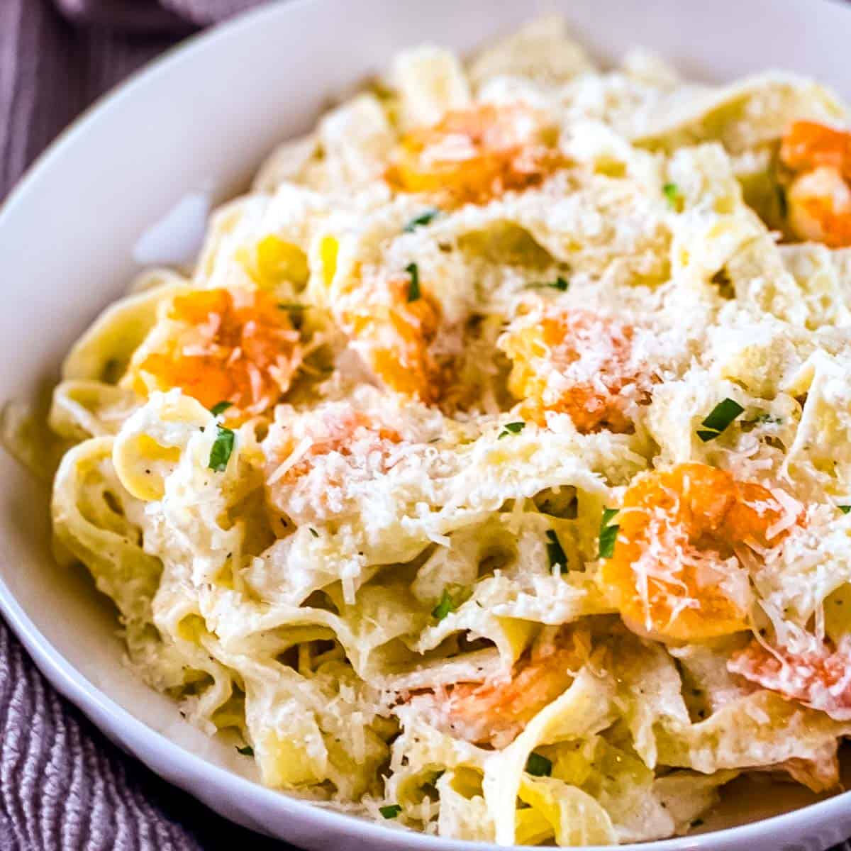 Olive Garden shrimp Alfredo copycat with creamy fettuccine, sautéed shrimp, and freshly grated Parmesan.